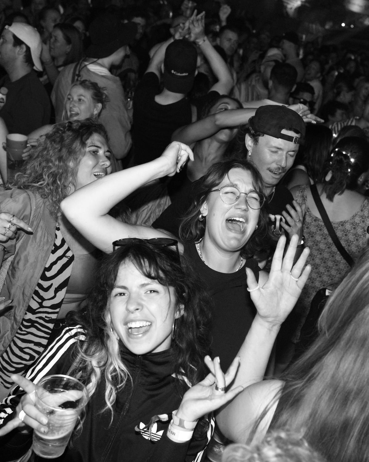 Crowd screaming along at a King Kong Kicks night, black and white flash photo