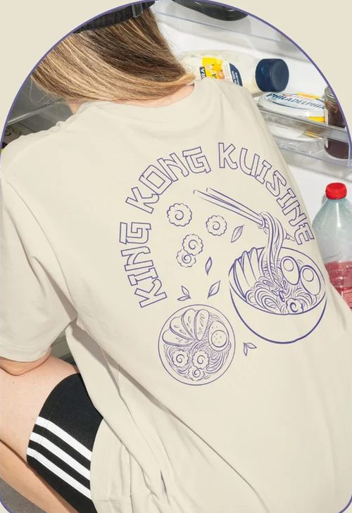 Beige King Kong Kuisine T-shirt with a purple noodle bowl and chopsticks drawing on the back