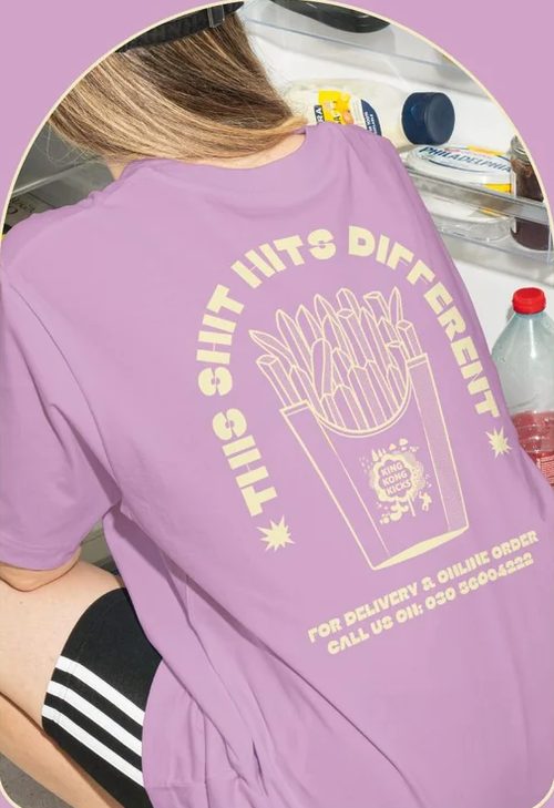 Lilac This Shit Hits Different T-shirt with a fries box print on the back